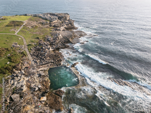 Stunning early morning aerial view of the Maroubra Rockpool in Sydney, Australia. Captured by drone at sunrise, showcasing natural beauty and coastal serenity.