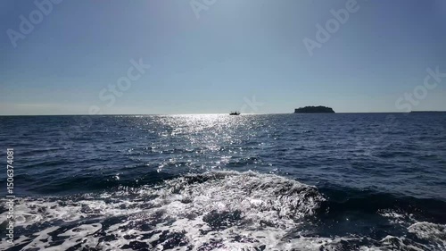 Sparkling Sea Under Clear Sky with Distant Boat