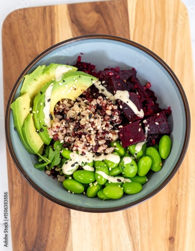 Healthy Vegan Gluten-Free Beetroot Poke Bowl with Brown Rice, Edamame, Avocado, Sesame Seeds, and Tahini Dressing – Plant-Based Wellness Meal on Wooden Board