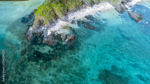 Quadro su tela The serene seascape of Okinawa showcases crystal-clear waters, exposed rocky formations, and gentle waves lapping against the shore