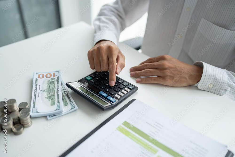Businessman checking bills taxes bank account balance and calculating annual financial statements of company. Accounting Audit Concept Businessman checking bills taxes bank account balance and calculating annual financial statements of company. Accounting Audit Concept