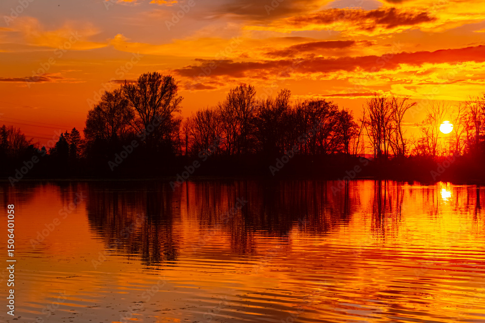 Spring sunset or sundowner view with reflections near Plattling, Isar, Deggendorf, Bavaria, Germany Spring sunset or sundowner view with reflections near Plattling, Isar, Deggendorf, Bavaria, Germany