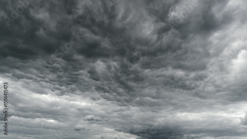 Slika na platnu The sky above is filled with dramatic overcast conditions, featuring dark and thick clouds Time lapse