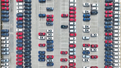 From above, the wide expanse of parked vehicles shows the intricate logistics involved in handling a large inventory of cars, with each car positioned for easy movement and swift transportation.
