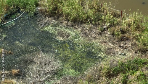 Tableau sur toile Drone view captures soil degradation and discoloration caused by industrial pollutants, with toxic buildup altering natural vegetation and microbial life