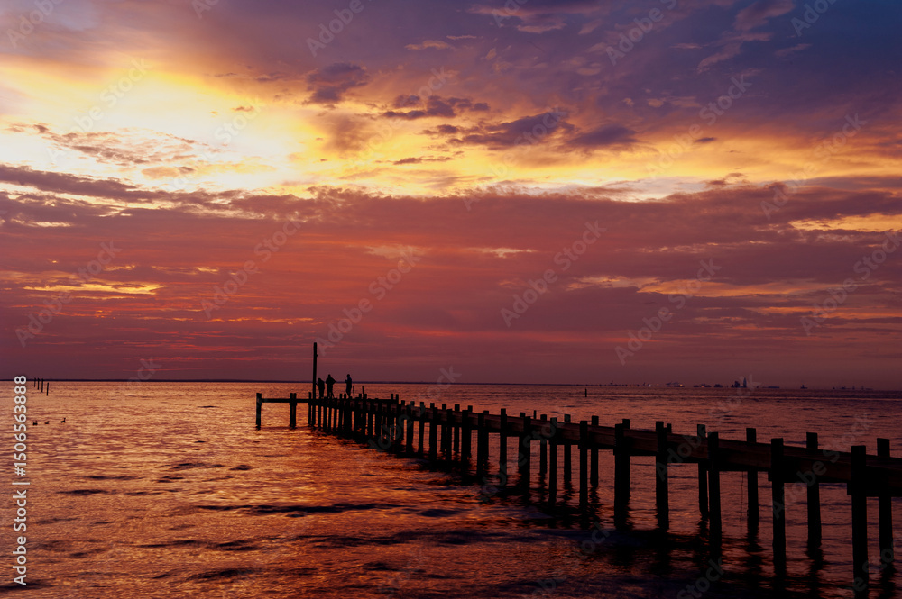 Fototapeta premium Sunset in Fairhoppe , Alabama with dramatic clouds.