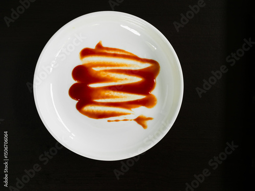 Dirty plate top view background, finished eat dinner in restautant, abstract textuer stain smearing drip sauce bbq jam chilli jelly on ceramic breakfast, concept for clean hyginene product.