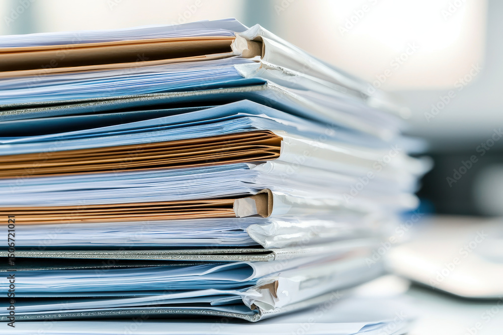 Business plan documents stacked neatly, showcasing organization and preparation for future projects Business plan documents stacked neatly, showcasing organization and preparation for future projects