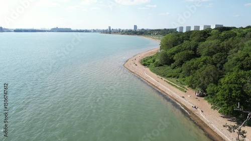Wallpaper Mural An aerial view captures the western shore of Southampton, featuring a sandy beach, lush greenery, and the city skyline in the distance under a clear sky. Torontodigital.ca