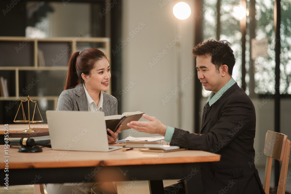 Male and female lawyers discuss legal matters in an office. Male and female lawyers discuss legal matters in an office.
