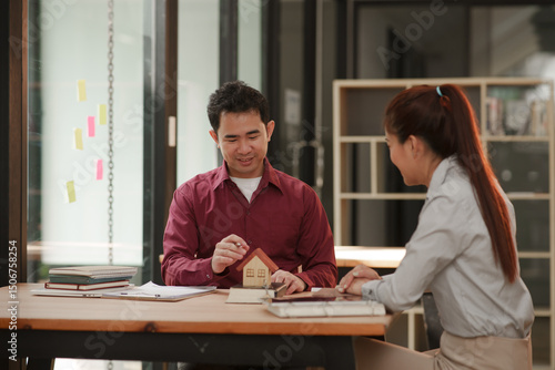 Male and female businessmen apply for a home loan in an office.