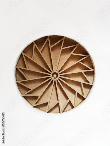 Architectural relief round wooden detail on white wall. Symbolic circular image. Copy space. Close-up.
