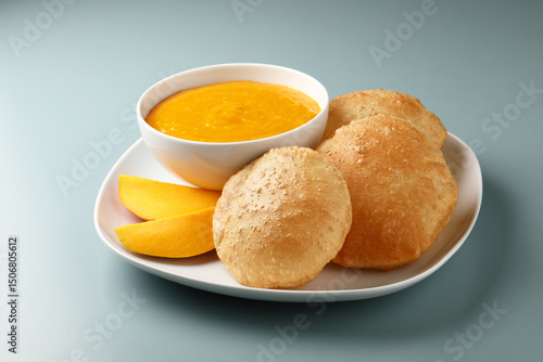 Tableau sur toile Aam ras served with puri and slice of mango