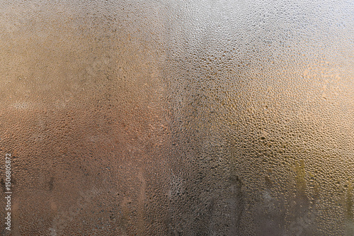 natural condensation forming on cold glass surface. water droplets, creating an abstract pattern. Cool atmosphere with transparent effect. drops on foggy window, blurring outside view. wet window.