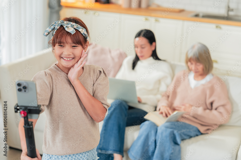 Fototapeta premium An Asian family multi genersation broadcast and vlogging in the living room during the celebration Senior woman and nephew vlogging using social media online conversation to her follower at home 