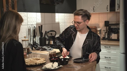 Friends gather in a modern kitchen, creating a casual celebration with drinks and joy