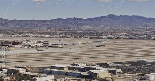 Las Vegas Nevada Aerial v96 zoomed low flyover Strip blvd, panning views capturing airport set against suburbs and a majestic mountain backdrop in daytime - Shot with Mavic 3 Pro Cine - Apr 30th 2024