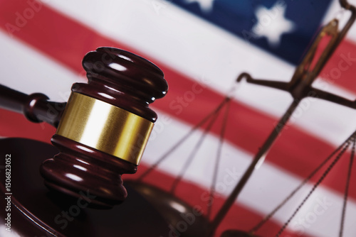 Judge gavel against United States national flag as symbol of judicial system of the USA. Justice, law and human freedom concept. Horizontal image. Close up.
