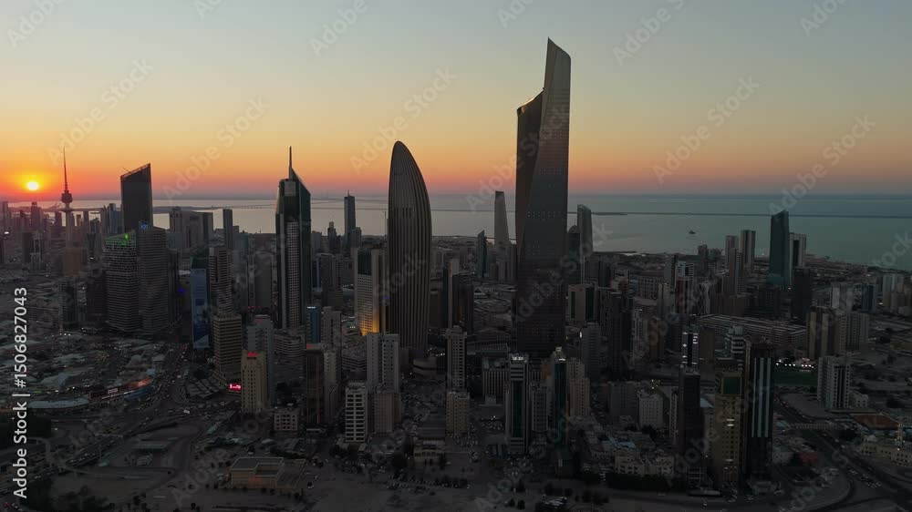 Breathtaking 4K drone shot of Kuwait City at sunrise. Towers glow under golden skies with the calm Gulf in the background. Ideal for cinematic, travel, or architectural footage. Breathtaking 4K drone shot of Kuwait City at sunrise. Towers glow under golden skies with the calm Gulf in the background. Ideal for cinematic, travel, or architectural footage.