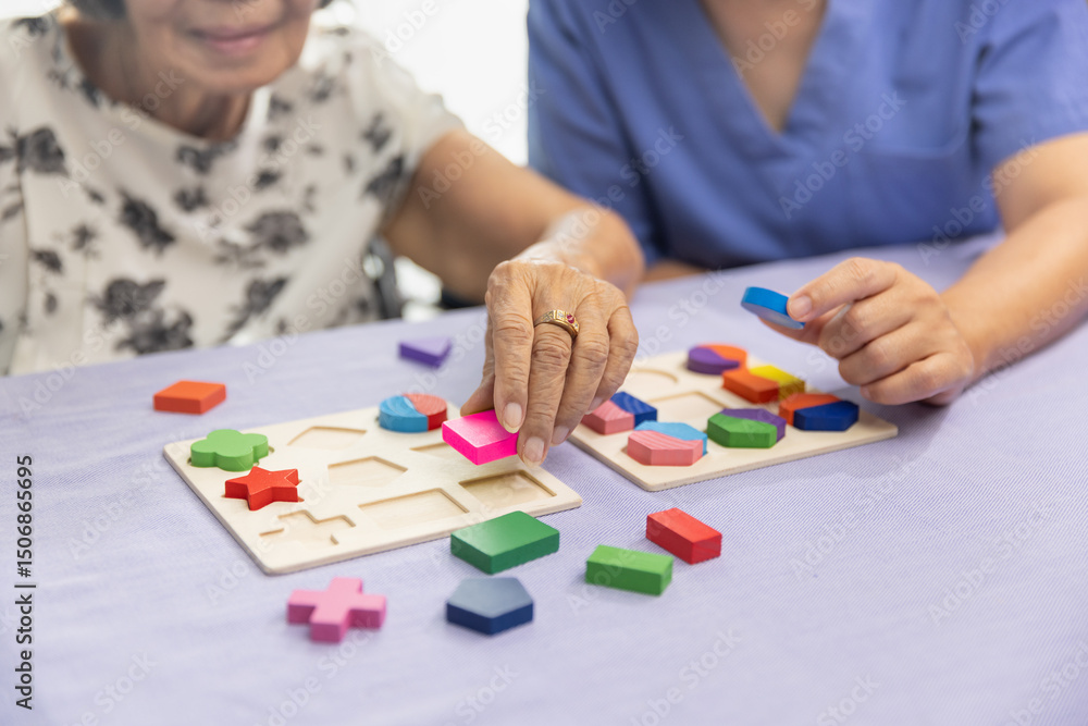 Caregiver and senior woman playing wooden shape puzzles game for dementia prevention. Caregiver and senior woman playing wooden shape puzzles game for dementia prevention.