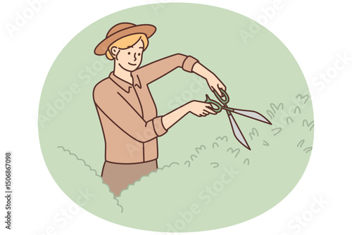 Woman gardener uses large scissors to shape bushes and remove diseased twigs