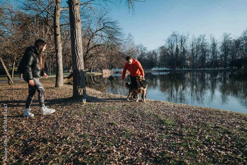 Fototapeta premium A couple spends quality time walking in a scenic park during sunset, alongside a calm lake, enjoying the peacefulness and autumn environment.