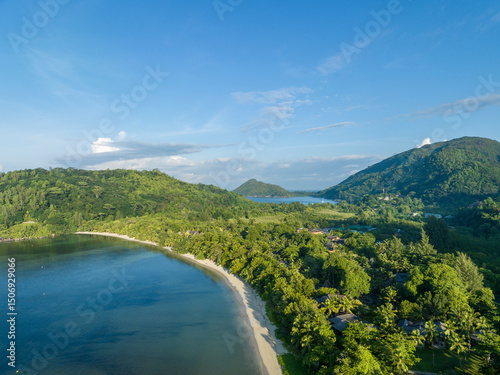 Aerial view of Port Launay Beach in Port Glaud, Mahe, Seychelles with lush greenery and a tranquil coastline.
