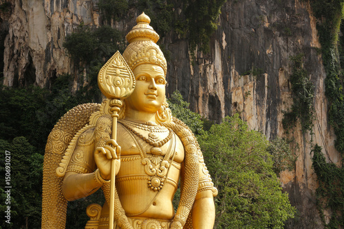 Canvas Print Golden statue of Lord Murugan (Kartikeya) towering at Batu Caves Hindu Temple, Kuala Lumpur, Malaysia