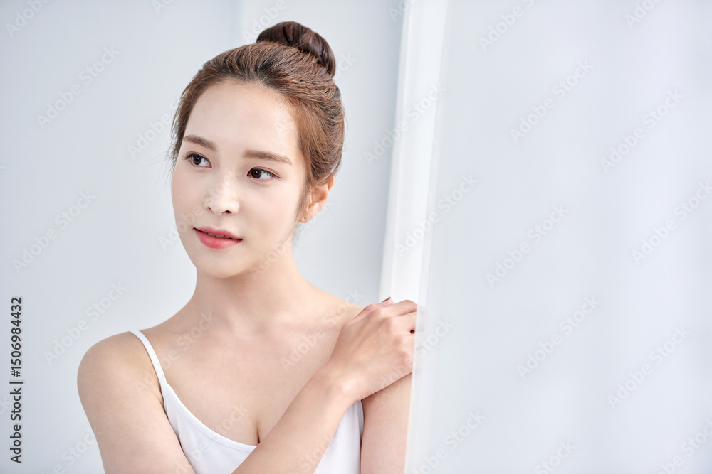 Young Asian Woman in White Tank Top with Elegant Updo, Minimalist Soft Light Portrait Young Asian Woman in White Tank Top with Elegant Updo, Minimalist Soft Light Portrait