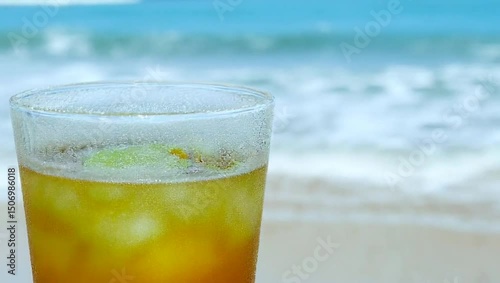 Refreshing Beachside Delight: A Frosted Cocktail by the Ocean Waves