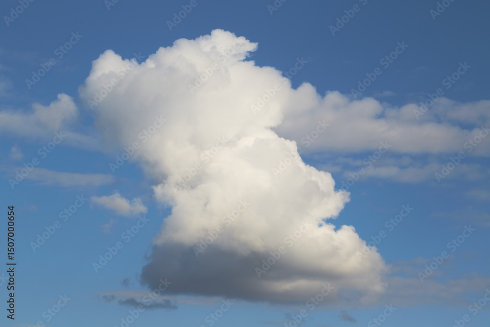 A solitary cloud against a bright sky background as a symbol of solitude, contemplation, and inner freedom. A solitary cloud against a bright sky background as a symbol of solitude, contemplation, and inner freedom.