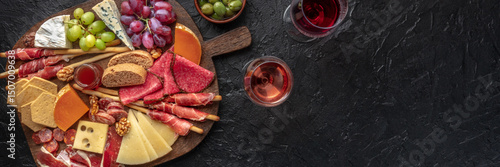 Antipasti or tapas. Charcuterie and cheese board with wine, overhead flat lay panorama with copy space