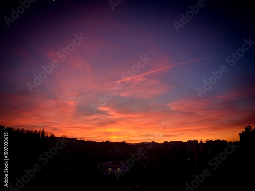Fotografie A view of the early evening red-tinged sky just after sunset