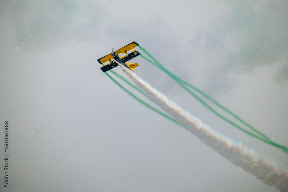 Fototapeta premium Wingwalker Stunt Over the Saudi Desert Aviation Daring at KSA Airshow
