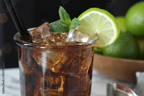 Photography Tasty Cuba Libre cocktail in glass on table, closeup