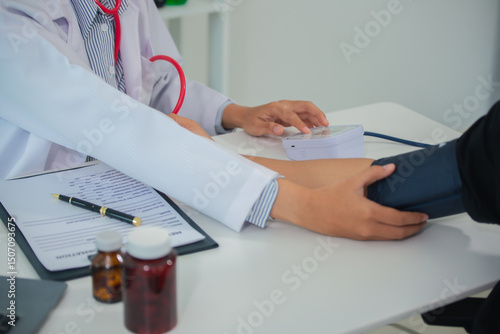 Cuadro en lienzo Female doctor gives advice and explains to patient for annual health check in examination room by measuring blood pressure and taking basic history