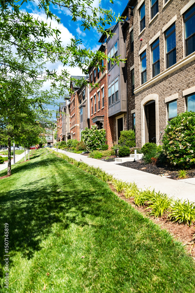 Apartment building with green lawn and long sidewalk along the wall. Apartment building with green lawn and long sidewalk along the wall.