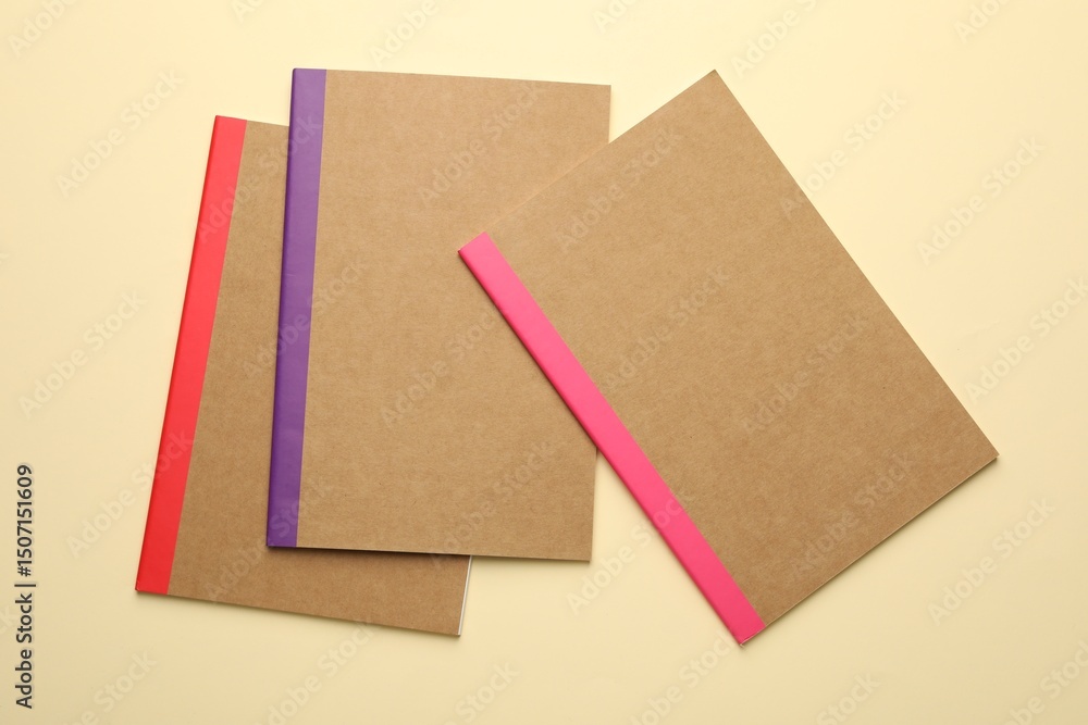 Fototapeta premium Different copybooks on beige background, flat lay