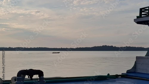 Fishing boats sail back home after fishing. Sunrise background.