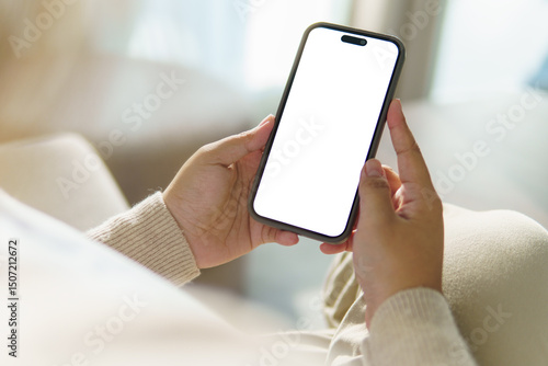 Close up of hands holding smartphone with blank white screen, for app mockups or UI design.