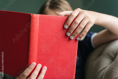 Book in child's hand with 