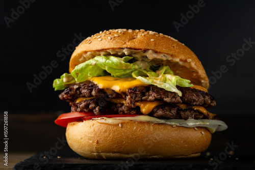 Close up of beef smach burger on dark surface