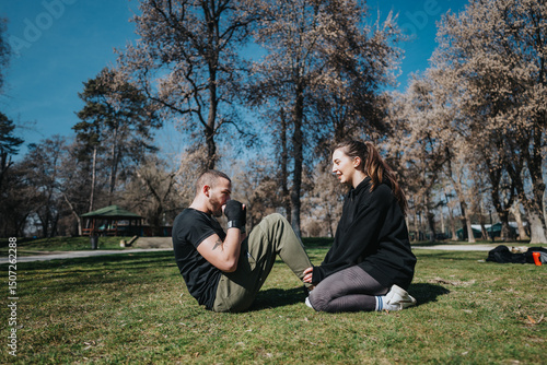 Bilde på lerret Two young teenagers engaging in a fitness session outdoors, displaying camaraderie and energy in a sunny park setting with a natural background