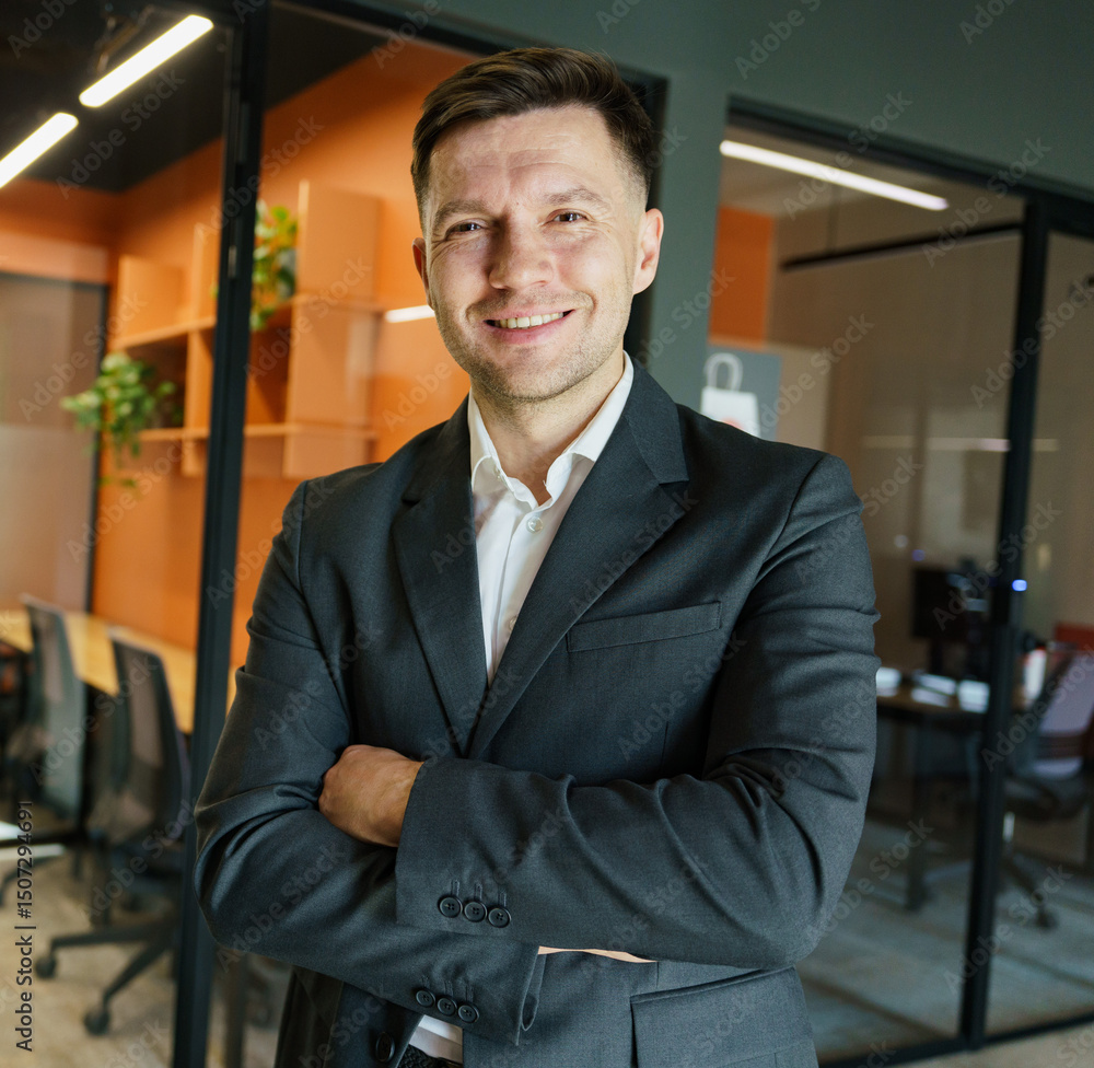 Fototapeta premium Confident professional smiling in a modern office setting with warm colors and sleek design elements