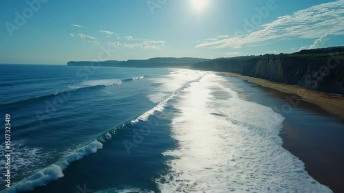 Aerial view ocean waves with sandy beach.
