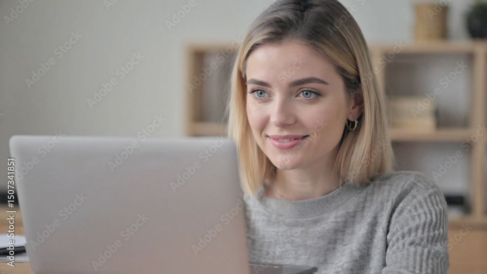Focused Woman with Laptop: A portrait captures a woman, focused and absorbed, working on her laptop, her eyes fixed on the screen, her face hinting at concentration and contemplation. Focused Woman with Laptop: A portrait captures a woman, focused and absorbed, working on her laptop, her eyes fixed on the screen, her face hinting at concentration and contemplation.