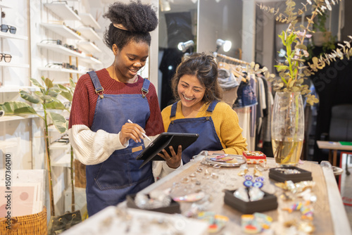 Sunglasses store employees using digital tablet