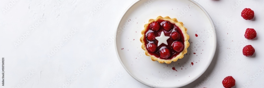 Elegant raspberry tart with star decoration on white plate Elegant raspberry tart with star decoration on white plate