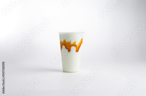 Milkshake with syrup in a glass. on a white background.