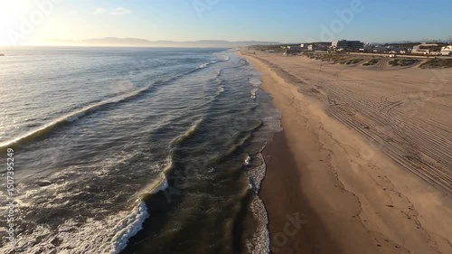 A dusk low aerial flyover of an empty Playa Del Rey Beach. Beaches were closed during the COVID-19 pandemic of 2020. Flown with FAA permission by a licensed pilot. Longer segments available.